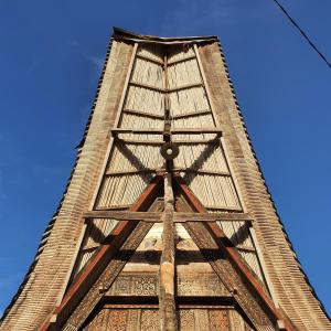 a tall clock tower with a blue sky in the background at Angel's Homestay Batutumonga in Rantepao