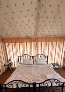 a bedroom with a bed with stars on the wall at Elefun Resort with organic farm in Middle of Nature in Jaipur