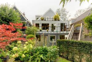 a house with a garden in front of it at Park View Apartment in Amsterdam