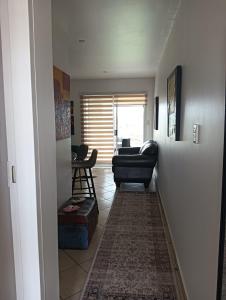 a living room with a couch and a chair at 612 @ Leisure Bay in Pretoria