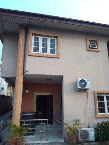 a white house with a porch and a window at Light house hotel in Lekki