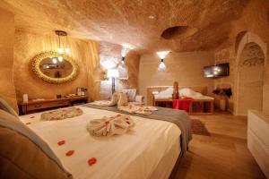 1 dormitorio con 1 cama grande y toallas. en Misty Cave Hotel, en Ürgüp