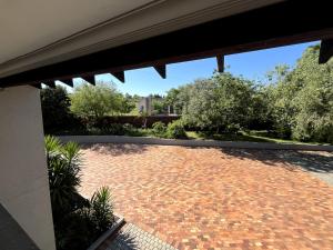 a brick patio with a view of a garden at Fair Glen in Kyalami