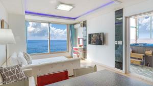 a living room with a view of the ocean at Buan arco spa pension in Buan