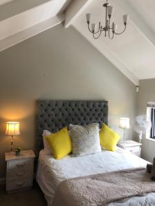 a bedroom with a large bed with yellow pillows at 19 Lagoon Terrace in Knysna