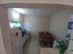 a small kitchen with a table and a refrigerator at Depto Lu 3 in Villa Mercedes