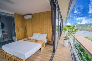 a bedroom with two beds on a balcony at DC AROMA VILLA - Venuestay in Hòa Bình