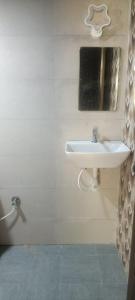 a bathroom with a sink and a mirror at Vattavada Jungle Resort in Munnar +18 photos