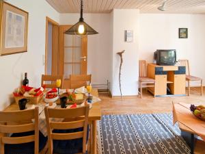 a dining room and living room with a table and chairs at Landhaus am Kienberg in Pfronten