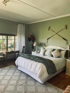 a bedroom with a large bed in a room at Tafeni Farm Cottages in Swartberg