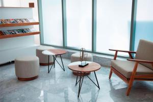 a living room with two chairs and a table at AC Hotel by Marriott Santa Fe in Mexico City