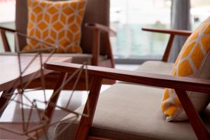 a room with two chairs and a wooden table at AC Hotel by Marriott Santa Fe in Mexico City