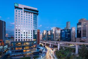 a city skyline with a tall building and freeway at AC Hotel by Marriott Santa Fe in Mexico City