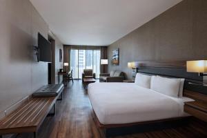 a hotel room with a bed and a living room at AC Hotel by Marriott Santa Fe in Mexico City