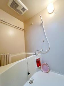 a bathroom with a bath tub with a shower at Space Tokyo House in Tokyo