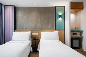 two beds sitting next to each other in a room at The Bayou Hotel Langkawi in Pantai Cenang