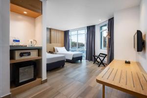 a hotel room with a bed and a fireplace at The Bayou Hotel Langkawi in Pantai Cenang