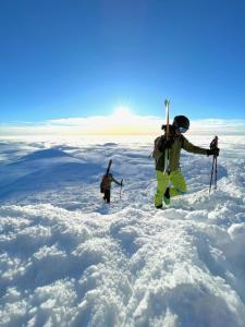 two people standing on top of a snow covered mountain at Gausta Lodge med 6 sengeplasser i nærhet til Gaustatoppen in Gaustablikk