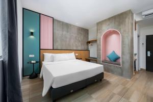 a bedroom with a large white bed in a room at The Bayou Hotel Langkawi in Pantai Cenang