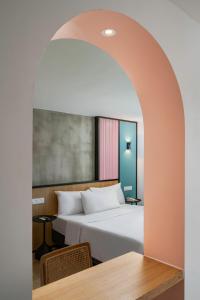 a bedroom with a large bed and a table at The Bayou Hotel Langkawi in Pantai Cenang