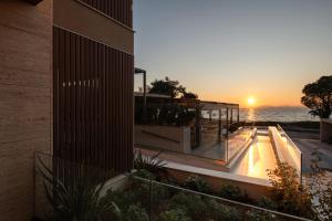 a building with a balcony with the sunset in the background at Oniro Boutique Hotel in Toroni