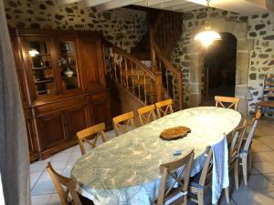 a dining room with a table and some chairs at Maison Chez Jeannot in Saint-Geneys-près-Saint-Paulien +21 photos