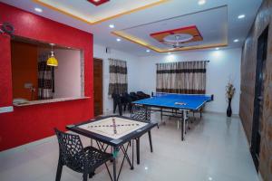 a room with two ping pong tables and chairs at Altitude Villa A Serene Retreat Panchgani in Panchgani