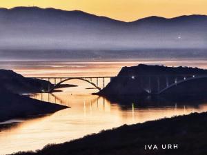 a bridge over a body of water at sunset at IGGY in Malinska