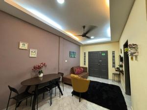 a living room with a table and a couch at VILLA SERI MUTIARA in Kuah