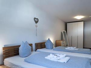 two beds in a room with blue and white at Fewo Am Mühlbach 5 AMB5 in Mittenwald