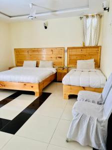 A bed or beds in a room at F R Darya e Swat Hotel