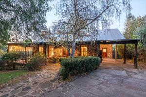 a house with a pavilion in front of it at The Enchanted Stone Cottage in Margaret River Town