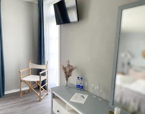 a dressing table with a mirror and a chair at Hotel Strandgaarden in Vesterø Havn +19 photos