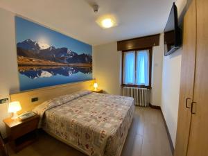Postel nebo postele na pokoji v ubytování Hotel Sciatori 3 Stelle Superior + 37 fotografií