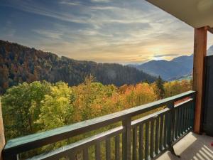 a balcony with a view of trees and mountains at Appartement Notre-Dame-de-Bellecombe, 2 pièces, 4 personnes - FR-1-505-100 in Notre-Dame-de-Bellecombe