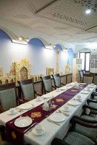 a long table in a room with chairs at Zargaron Plaza in Bukhara