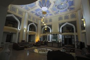 a large lobby with a blue and white ceiling at Zargaron Plaza in Bukhara