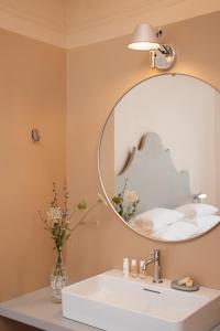 a bathroom with a sink and a mirror at Der Pfarrhof in Hartberg