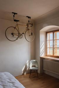 a bike hanging on the wall in a bedroom at Der Pfarrhof in Hartberg
