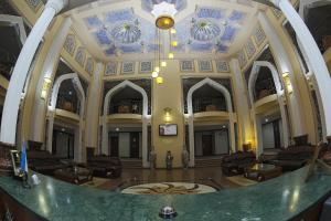 a large lobby with a blue and white ceiling at Zargaron Plaza in Bukhara