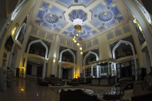 a large lobby with a blue and white ceiling at Zargaron Plaza in Bukhara