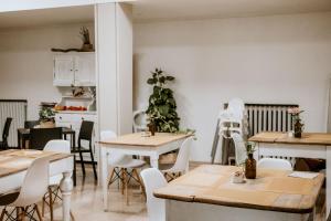 a dining room with tables and chairs and a kitchen at Hotel Venezia in Trento