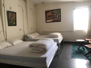 Postel nebo postele na pokoji v ubytování iDorm B&B - idorm Mỹ