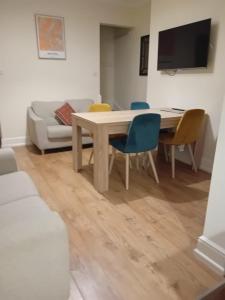 a living room with a table and chairs and a couch at Colville House in Lincolnshire