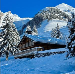 a log cabin in the snow on a mountain at SmartStay - Chalet Felix aux Confins in La Clusaz