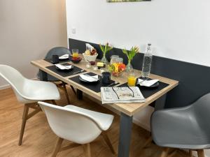 a dining room table with chairs and food on it at Ferienwohnung Ingrid in Freyung