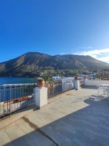 a balcony with a view of the ocean and mountains at Hotel Faraglione in Vulcano