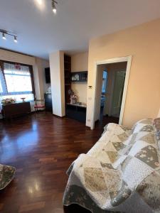 a living room with a bed and a wooden floor at Ostia Sunsets • Home near Rome and Airport in Lido di Ostia