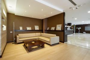 a living room with a couch and a coffee table at Sercotel Sant Boi in Sant Boi del Llobregat