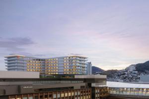 a view of a building with a city in the background at Nagasaki Marriott Hotel in Nagasaki